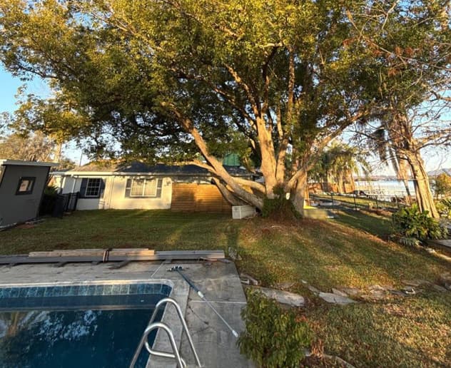 Team using rigging and crane to remove tree sections