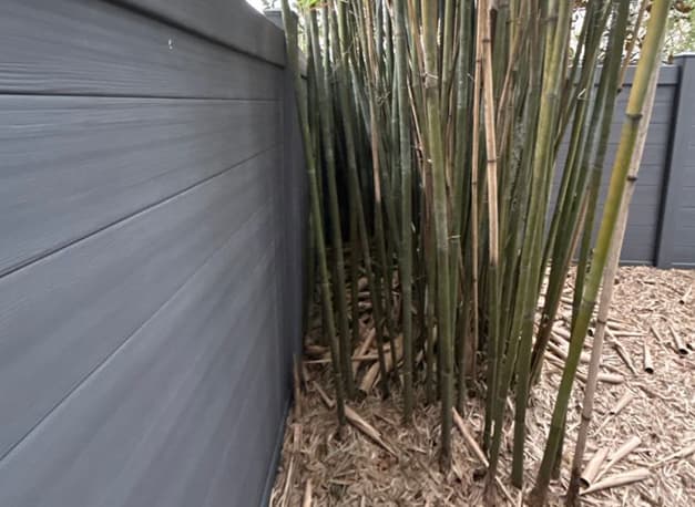 Team working carefully around fence and windows